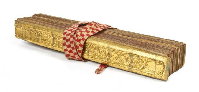 A Religious Text, Burma, Width 18 3/8 inches.: A Religious Text, Burma, containing fifteen pages, having inscription and Buddhist scenes, the pages are leaf of cotton or lacquer, having two conforming gilt wood covers. Width 18 3/8 inches. Propert