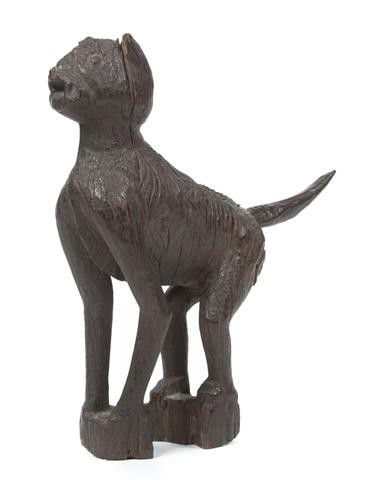 A Tiger Form Carved Wood Deity Figure, Borneo, He: A Tiger Form Carved Wood Deity Figure, Borneo, the hardwood figure in the form of a cat, in a forward facing pose, with tail extending outward at back, having dark patina throughout. Height 9 1/2 inch