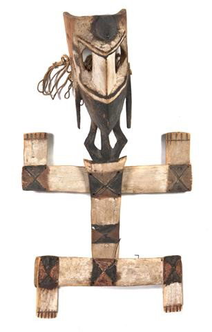 A Dogon Lizard Mask, Height 35 inches.: A Dogon Lizard Mask, comprised of multiple plank-like elements above a carved wood mask, having white, brown and red pigments, with cotton textiles. Height 35 inches. Property from the Laurence Rathsa