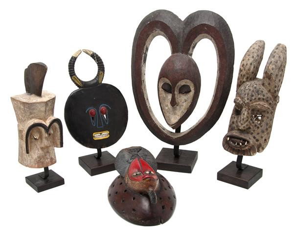 A Collection of Five African Carved and Polychrom: A Collection of Five African Carved and Polychrome Decorated Masks, of various forms, each mounted on a later base. Height of tallest 18 1/2 inches. Property from the Collection of Mr. and Mrs. John F