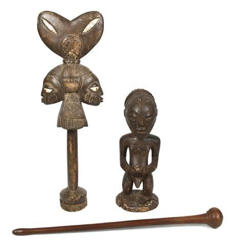 A Group of Three Carved Wood Objects, Yoruba, Len: A Group of Three Carved Wood Objects, Yoruba, comprising a dance wand, having globular finial and tapering shaft, a squatting figure of a male on circular base, and a two-faced dance wand, having appl
