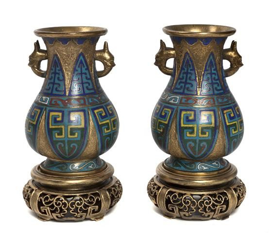 A Pair of Chinese Cloisonne Vases, Height 7 1/4 in: A Pair of Chinese Cloisonne Vases, having gilt reserves and animal form handles, with stiff plantain leaf form enameled panels throughout, with Dao Guang mark, raised on giltwood stands. Height 7 1/4 