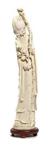 A Chinese Ivory Carving, Height 18 3/8 x width 3 1: A Chinese Ivory Carving, depicting a model of Shoulao in a standing position holding a staff and fruit branch. Height 18 3/8 x width 3 1/2 x depth 2 3/4 inches. Property from The Dayton Art Institute,