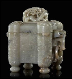 A Jade Archaistic Style Lidded Vessel, Height 5 3/: A Jade Archaistic Style Lidded Vessel, of grey colored stone with brown inclusions, of rectangular form having pierced domed dragon form finial atop the lid with carved roundels in the corners, the ma