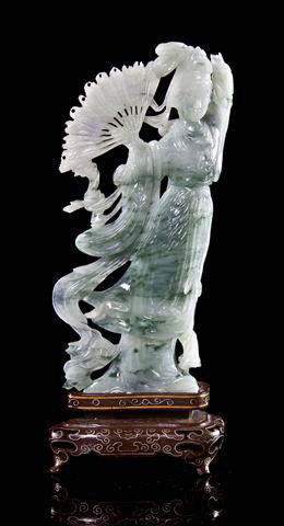 A Jadeite Figure of a Lady with a Fan, Height 6 1/: A Jadeite Figure of a Lady with a Fan, of mottled green and white stone, raised on a fitted wood base. Height 6 1/2 inches. Property from the Collection of Mr. and Mrs. John F. Monroe, Milwaukee, Wisc