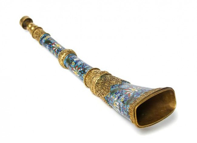 A Southeast Asian Cloisonne Enamel Trumpet, Length: A Southeast Asian Cloisonne Enamel Trumpet, of tapering form with scrolling foliate decoration throughout in three bands with blue reserves, having gilt banding and mouth piece. Length 16 inches.