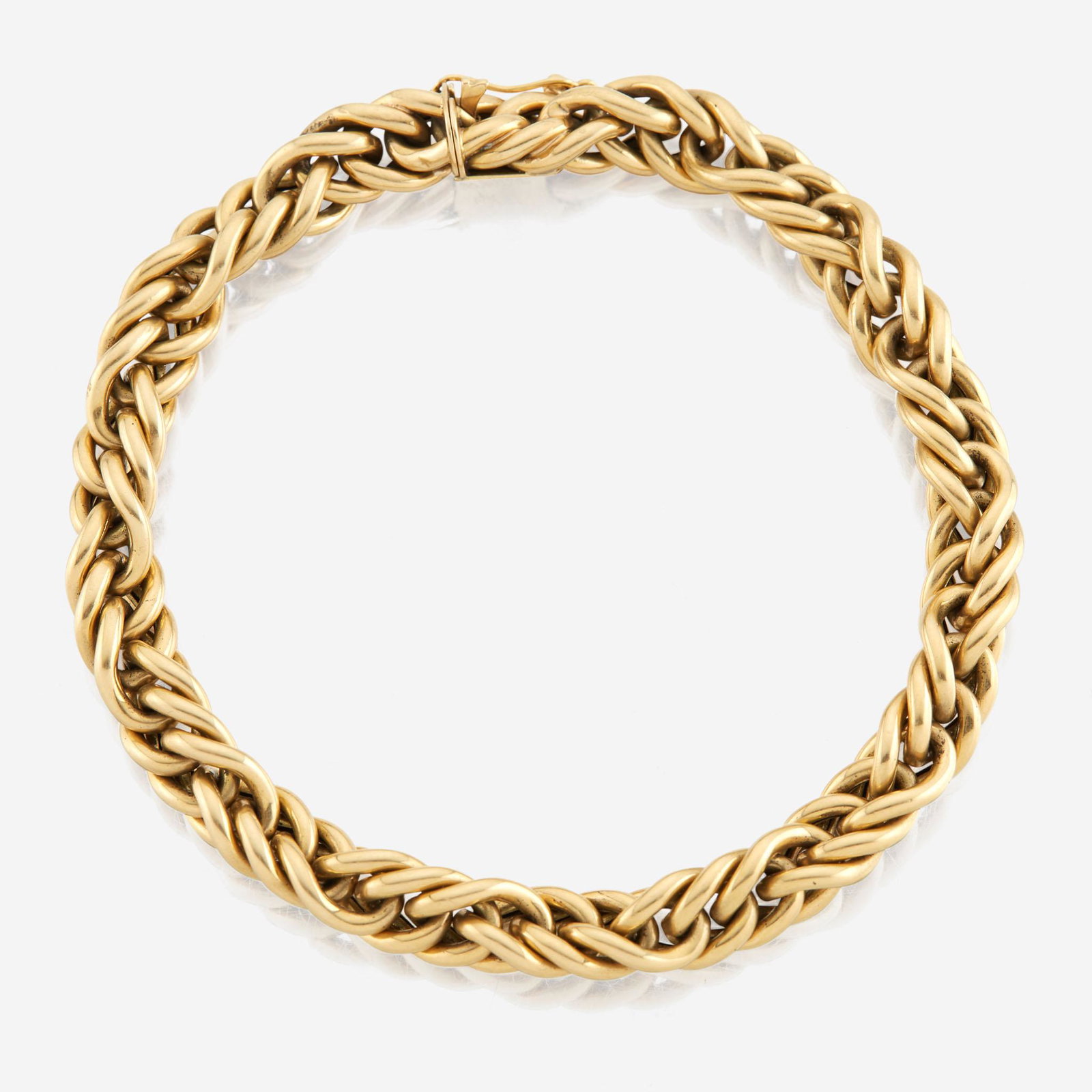 A gold bracelet, Cartier France: A gold bracelet, Cartier France designed as twisting 18K gold curb links. (13.9 dwt.; Length: 8 in.) Please note that the all information provided such as weights, grades, color, clarity are approxima
