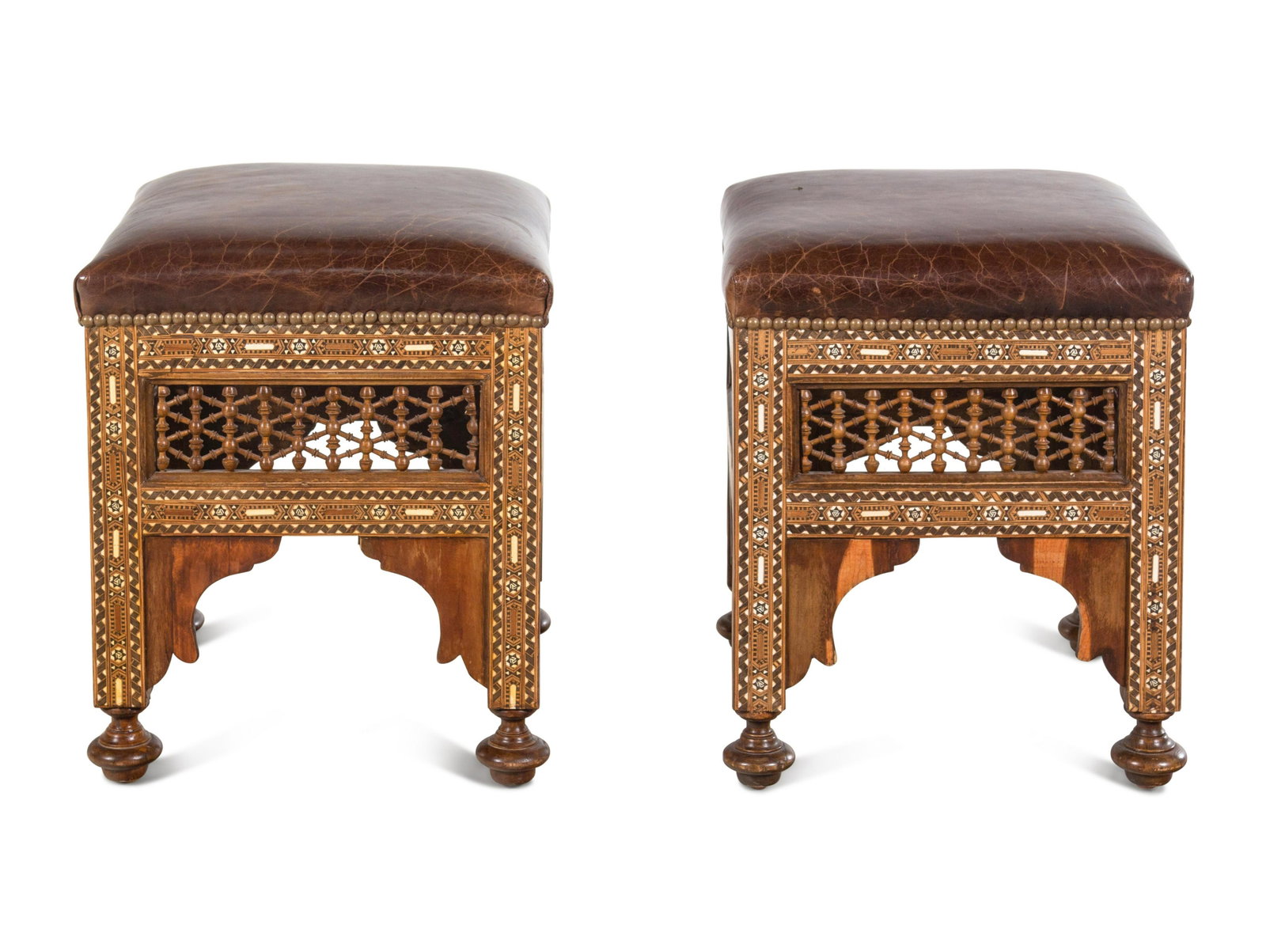 A Pair of Syrian Bone Inlaid Ottomans with Leather Upholstery: A Pair of Syrian Bone Inlaid Ottomans with Leather Upholstery Late 19th Century Height 19 1/2 x width 16 1/2 inches. Property from Hilary Swank's Private Collection