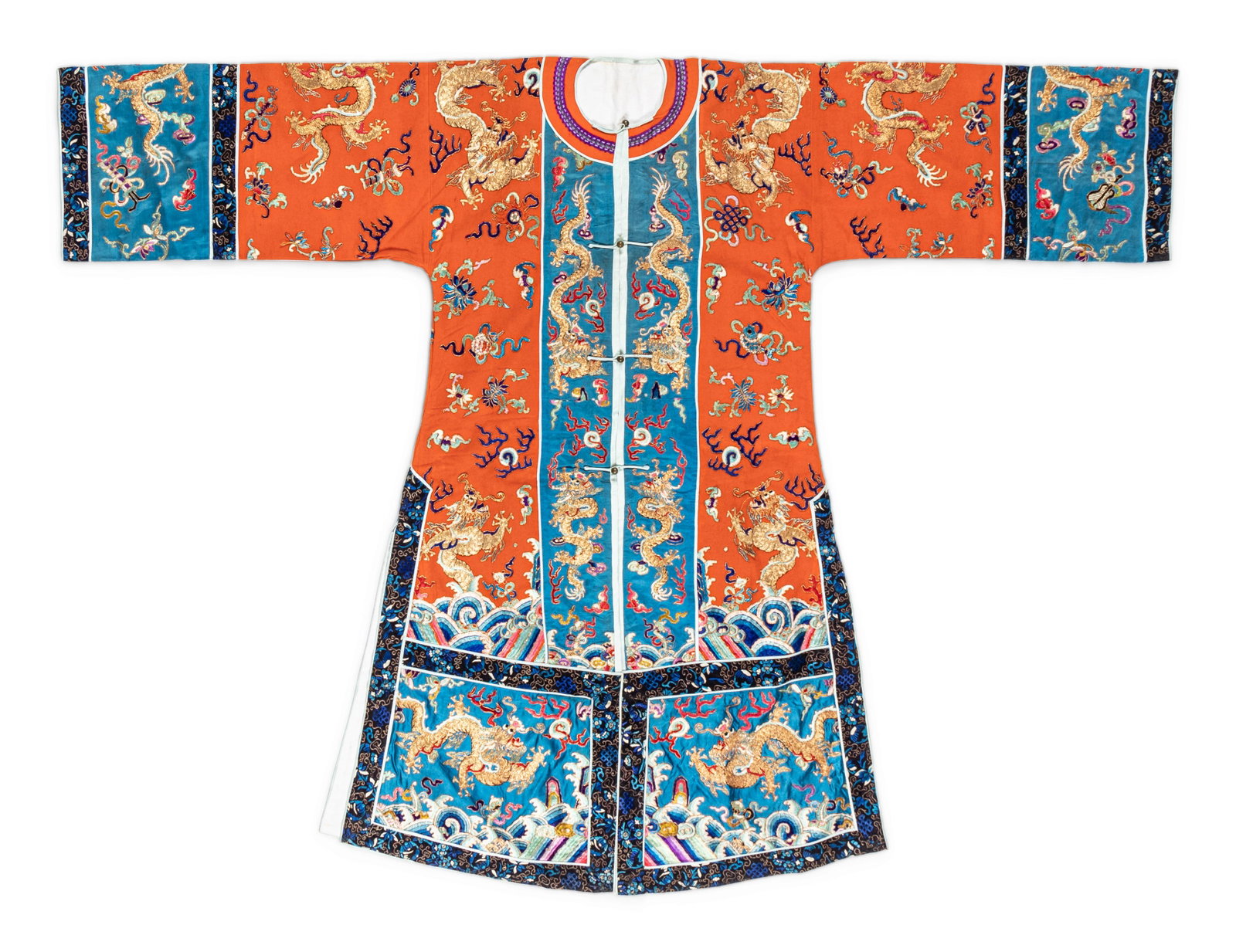 A Chinese Apricot Ground Embroidered Lady's Robe: A Chinese Apricot Ground Embroidered Lady's Robe THE EMBROIDERY: LATE 19TH/EARLY 20TH CENTURY worked with beribboned auspicious symbols and dragons of couched gilt threads against a blue silk ground a
