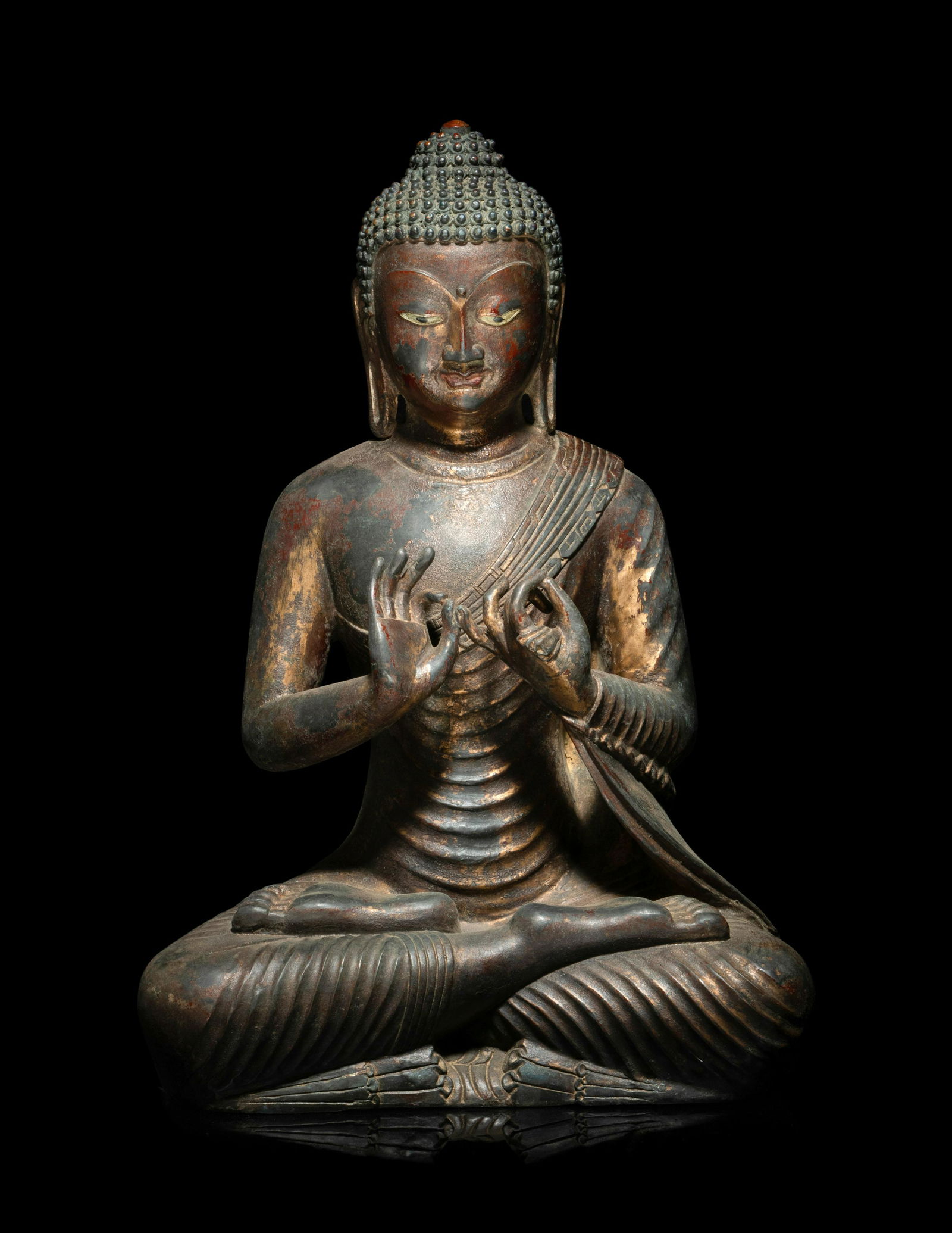 A Chinese Bronze Figure of Buddha: A Chinese Bronze Figure of Buddha depicted seated in a meditation posture clad in close-fitting robes. Height 14 1/2 in., 27 cm.