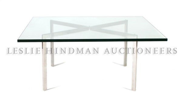 A Barcelona Low Table, Knoll, after a design by Mies: A Barcelona Low Table, Knoll, after a design by Mies van der Rohe, the square glass top over the X-form support. Height 16 7/8 x width 40 x depth 40 inches. Property from the Estate of Marjorie C. Bar