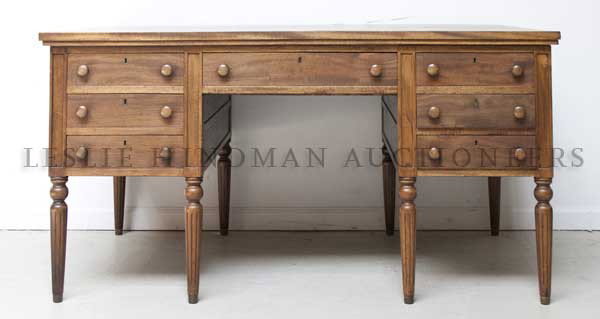 An American Mahogany Partner's Desk, Height 29 x wi: An American Mahogany Partner's Desk, 20th century, having a rectangular top over a series of drawers, raised on fluted legs. Height 29 x width 54 x depth 34 inches.