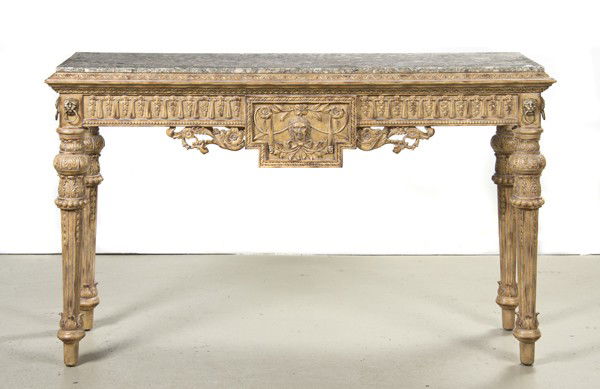 A Neoclassical Console Table, Height 37 x width 60: A Neoclassical Console Table, the rectangular veneered marble top above a carved frieze with applied lion mask decoration, raised on fluted tapering legs. Height 37 x width 60 x depth 20 inches.