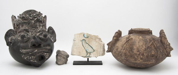 A Collection of Primitive Pottery Articles, Height: A Collection of Primitive Pottery Articles, comprising a circular low jar with applied mask decoration, a blackware oil lamp in the form of a head with a spout, an Egyptian hieroglyph fragment and a f