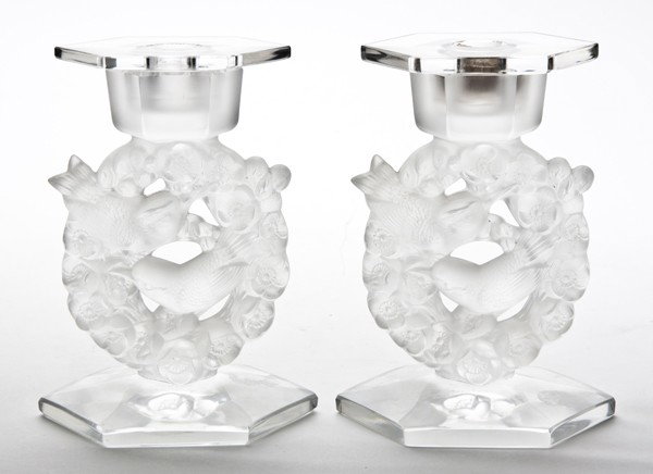 A Pair of Lalique Molded and Frosted Glass Candles: A Pair of Lalique Molded and Frosted Glass Candlesticks, each with bird in wreath decoration, raised on a hexagonal foot. Height 6 3/4 inches. From the Collection of William Kentor of Highland Park, I