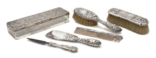 An Assembled Sterling and Silver Mounted Dresser S: An Assembled Sterling and Silver Mounted Dresser Set, comprising two brushes, a comb, a file, a shoe horn and a box. Length of longest 9 inches. Property from the William H. Moore Trust, Dorset, Vermo