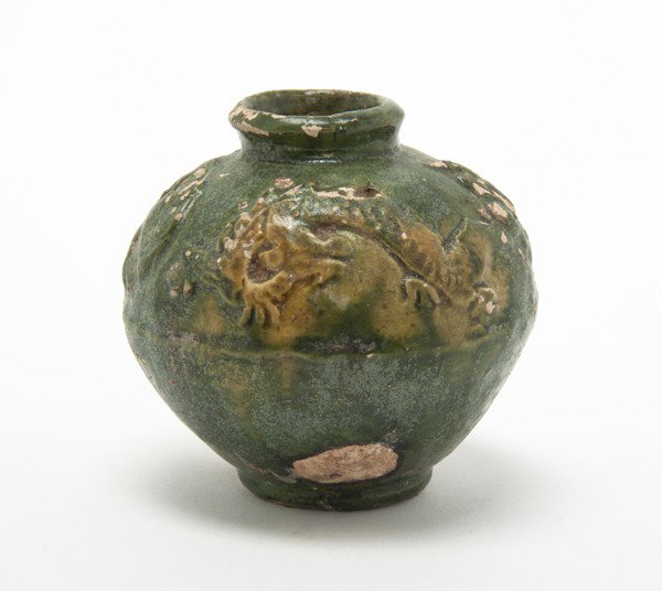 A Chinese Glazed Pottery Vessel, Height 2 3/4 inch: A Chinese Glazed Pottery Vessel, likely Tang dynasty, having molded decoration throughout. Height 2 3/4 inches. Property from the William H. Moore Trust, Hobe Sound, Florida