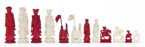 A Chinese Export Ivory Chess Set and Game Box, Hei: A Chinese Export Ivory Chess Set and Game Box, comprised of a full set with half of the items with a red stain. Height of tallest 3 3/4 inches.