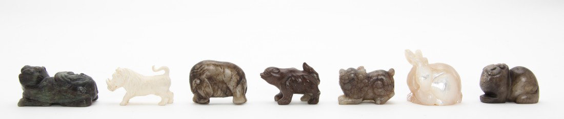A Collection of Jade Animal Form Toggles, Length o: A Collection of Jade Animal Form Toggles, comprised of dogs, an elephant, a bear, together with an ivory boar and a mother of pearl rabbit; 7 items total. Length of longest 2 inches. Property from a P