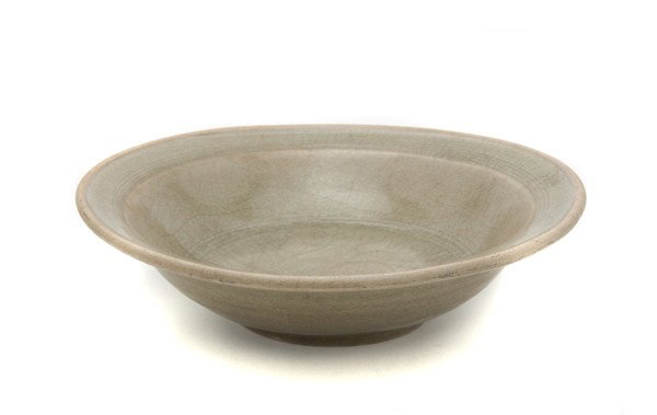 A Southeast Asian Celadon Glazed Porcelain Bowl, D: A Southeast Asian Celadon Glazed Porcelain Bowl, having carved interior decoration with olive green glaze throughout. Diameter 10 5/8 inches. Property from the Collection of Mr. and Mrs. John F. Monro