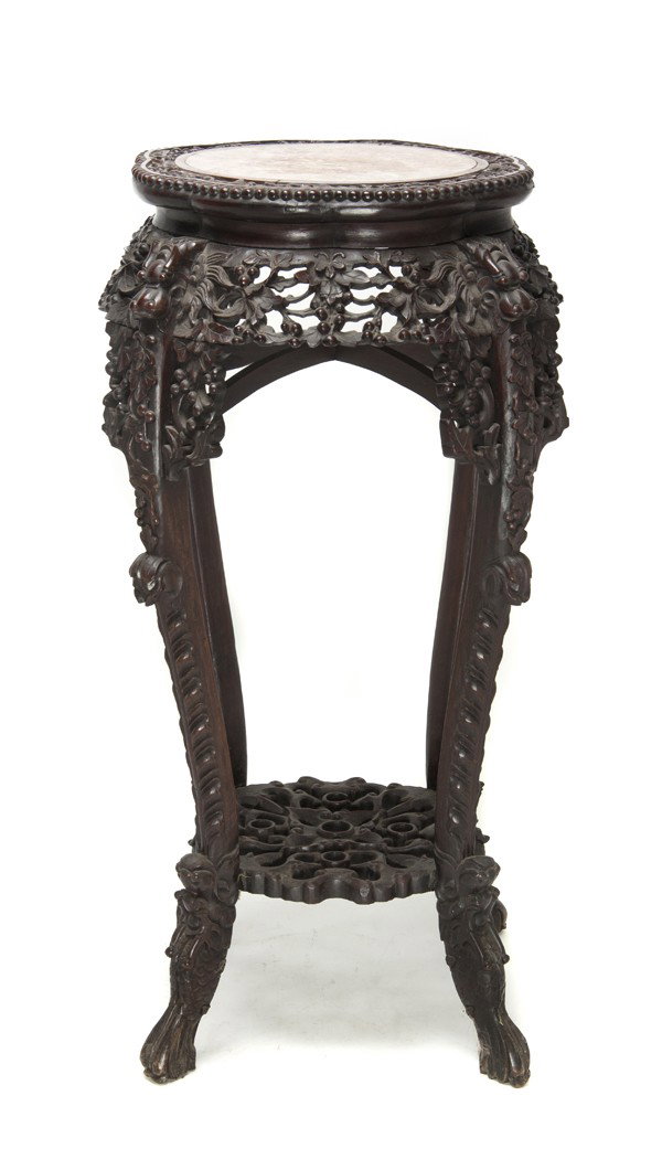 A Chinese Carved Hardwood Stand, Height 32 inches.: A Chinese Carved Hardwood Stand, the frame heavily carved, with inset rouge marble top. Height 32 inches. Property from the Collection of Mr. and Mrs. John F. Monroe, Milwaukee, Wisconsin