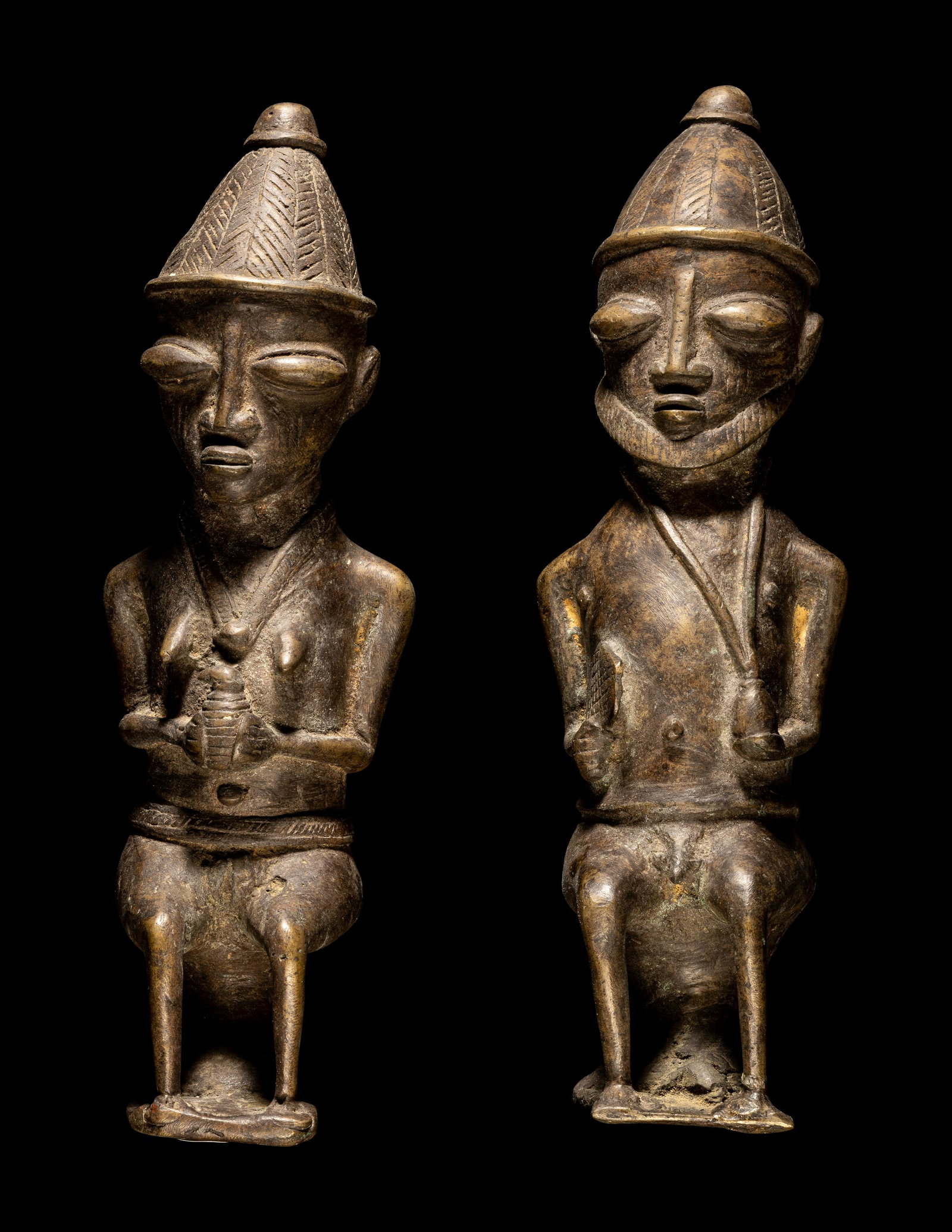 Two Ogboni Brass Male and Female Seated Figures Height of tallest 11 11/16 inches (29.8 cm).: Two Ogboni Brass Male and Female Seated Figures West Africa, Nigeria Height of tallest 11 11/16 inches (29.8 cm). Property from the Collection of Georgette D'Angelo, Glencoe, Illinois Provenance: Acqu