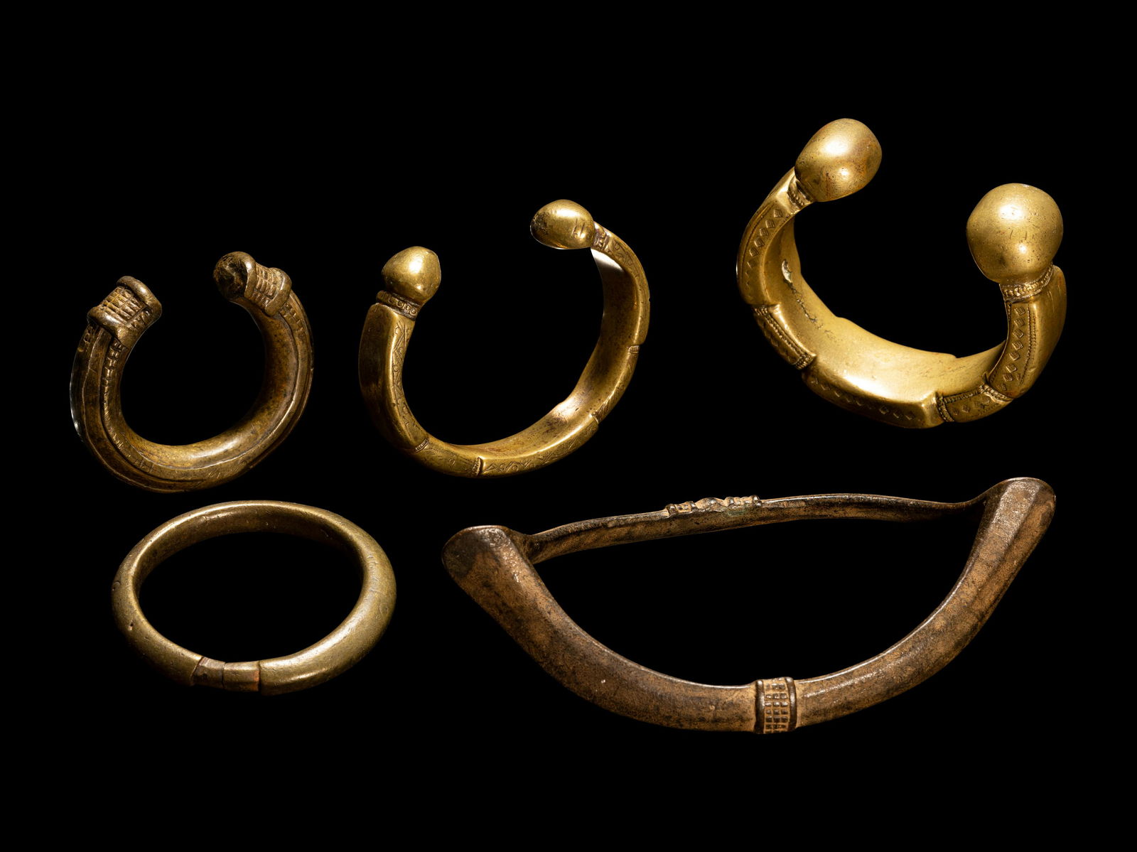 Five African Metalwork Currency Bracelets Diameter of largest 6 3/4 inches (17.2 cm). (1 of 3)