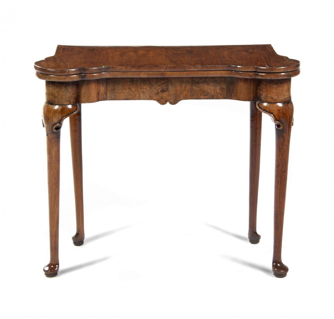 A Queen Anne Walnut Flip-Top Games Table, Height 27: A Queen Anne Walnut Flip-Top Games Table, the rectangular top opening to a square having a leather inset playing surface over the plain frieze raised on tapering legs ending in pad feet. Height 27 x w