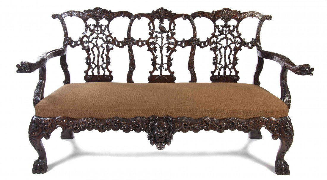 An Irish Triple Back Settee, Height 39 1/2 x width : An Irish Triple Back Settee, each pierce carved splat with bird, ribbon and oak leaf decoration over the open dolphin carved arms flanking the upholstered seat, the frieze centered with a carved mask,