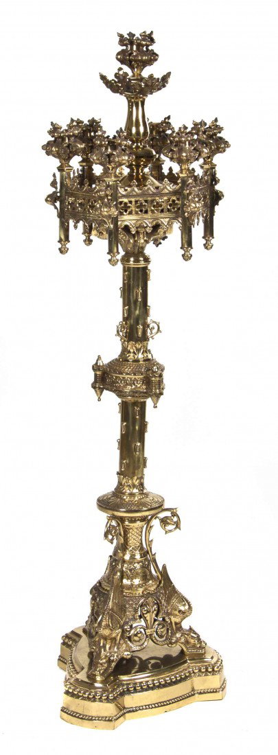 A Gothic Revival Polished Brass Torchiere, Height 6: A Gothic Revival Polished Brass Torchiere, having a hexagonal superstructure with six lighting elements at the points and centering a seventh, raised on a baluster form standard and set on a tripartit