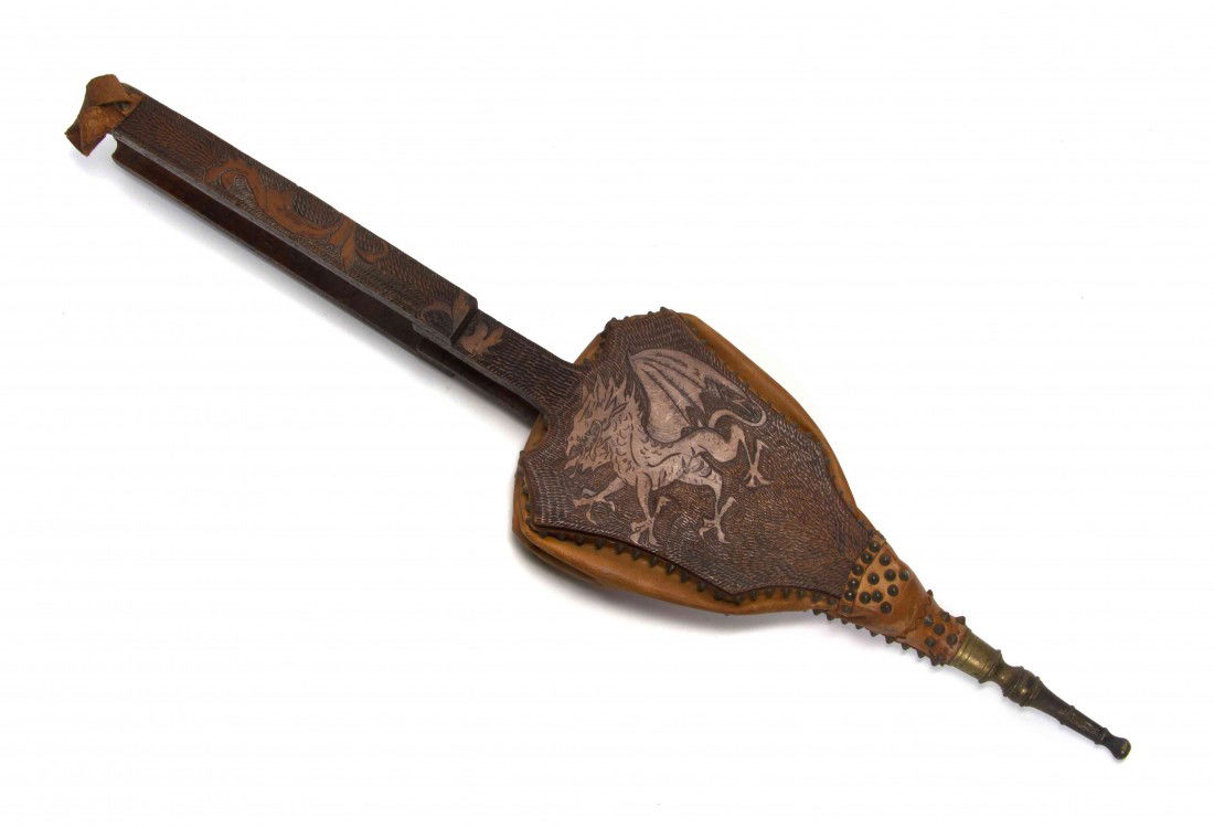 A Pyrographic Decorated Wood and Leather Bellows,: A Pyrographic Decorated Wood and Leather Bellows, with dragon and sun decoration, initialed H, with leather bellows and strap. Length 41 inches.