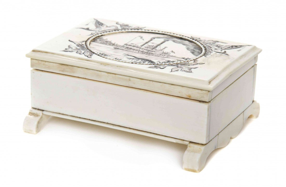 An American Ivory Playing Card Case, Height 2 3/8: An American Ivory Playing Card Case, the rectangular top decorated with a steamboat within a flag and leaf border, the fitted interior having two small decks of cards, chips and dice. Height 2 3/8 x w