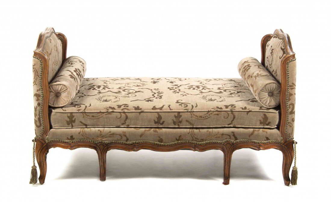 A Louis XV Style Walnut Day Bed, Height 34 x width: A Louis XV Style Walnut Day Bed, having shaped sides, upholstered in a velvet fabric with gilt accents and two pillows, raised on cabriole legs. Height 34 x width 58 3/8 x depth 29 1/2 inches.