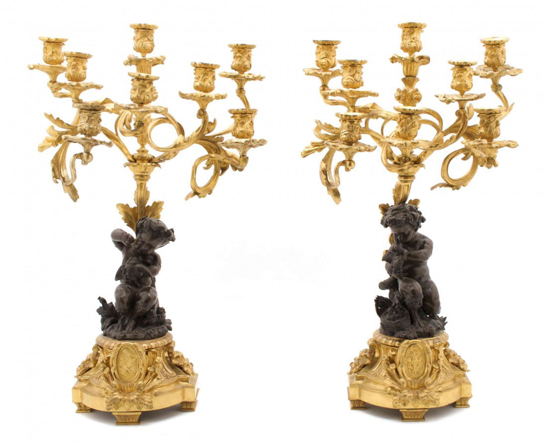 A Pair of French Eight-Light Gilt and Patinated Br: A Pair of French Eight-Light Gilt and Patinated Bronze Candelabra, attributed to Henri Picard, cast in the form of mischievous young satyrs tormenting birds. Height 25 3/4 inches.