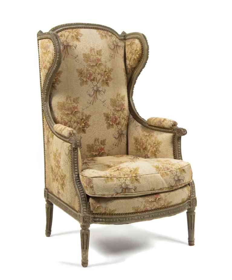 A Louis XVI Style Wingback Armchair, Height 45 inc: A Louis XVI Style Wingback Armchair, having a curved crest rail over the upholstered arms, back and seat, raised on fluted tapering legs. Height 45 inches.