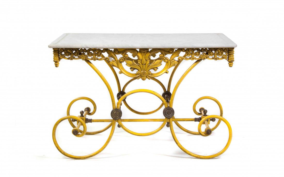 A French Marble and Wrought Metal Pastry Table, He: A French Marble and Wrought Metal Pastry Table, having a rectangular top over the scrolling foliate frieze over the scrolling legs joined by stretchers. Height 31 x width 48 x depth 29 inches.