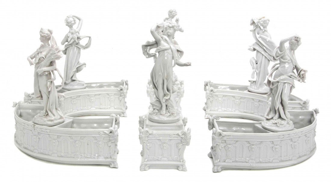 A Capodimonte Blanc de Chine Porcelain Table Garni: A Capodimonte Blanc de Chine Porcelain Table Garniture, of circular segmented form, decorated with classical maidens, having crowned N mark in underglaze blue. Height overall 9 inches.