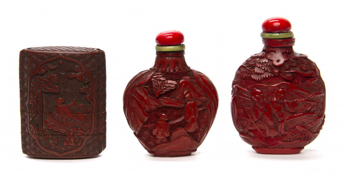 A Group of Two Cinnabar Lacquer Snuff Bottles, Hei: A Group of Two Cinnabar Lacquer Snuff Bottles, each having figural and landscape decoration with glass stoppers, together with a four compartment cinnabar lacquer inro. Height of tallest bottle 2 3/4