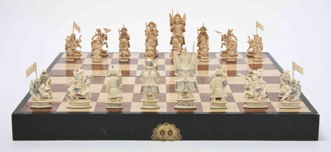 A Chinese Ivory Chess Set, Height of tallest figur: A Chinese Ivory Chess Set, comprising 32 ivory chess figures inside of the fitted game board. Height of tallest figure 4 1/2 inches.