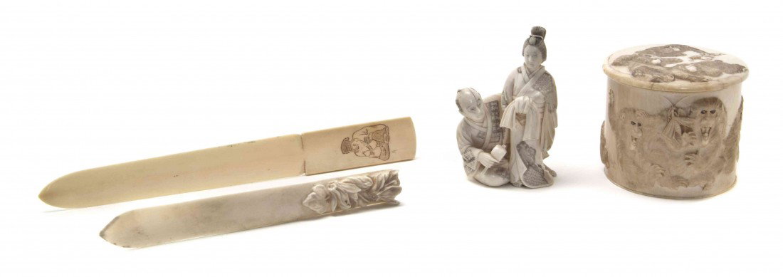 A Japanese Carved Ivory Box, Height of first 2 3/4: A Japanese Carved Ivory Box, of circular form decorated with monkeys in relief, together with an ivory okimono and two ivory letter openers. Height of first 2 3/4 x diameter 2 7/8 inches.