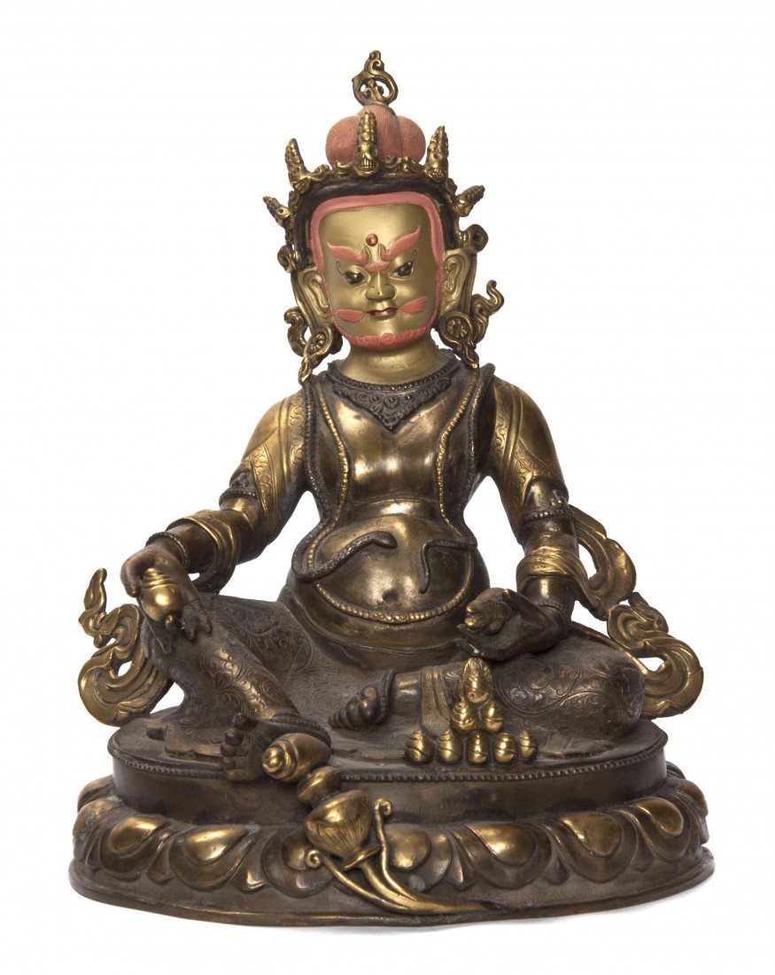A Southeast Asian Bronze Figure of a Deity, Height: A Southeast Asian Bronze Figure of a Deity, the figure having head dress with multiple skull finials above the polychrome and gilt face with thin mustache and beard, with rotund mid section and seated