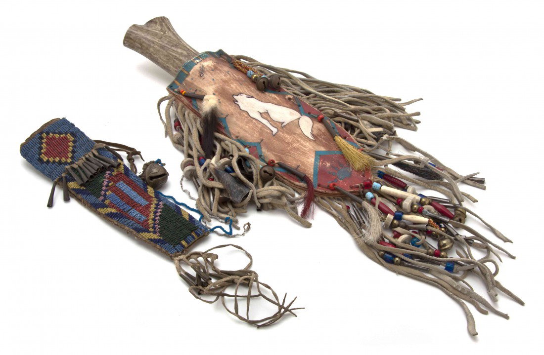 A Native American Sheath, Length of first 9 inches: A Native American Sheath, having beaded and bell decoration, together with a bone handled knife in a leather sheath with polar bear decoration. Length of first 9 inches. Property from the Estate of No