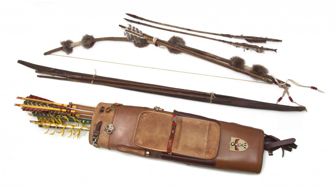 A Collection of Native American Bows and Arrows, L: A Collection of Native American Bows and Arrows, comprising a hide and fur wrapped bow and metal and flint tipped arrows, together with quiver having beaded decoration. Length of bow 38 inches. Proper