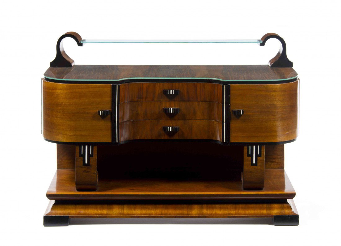 An Art Deco Mahogany Vanity, Height 64 x width 48: An Art Deco Mahogany Vanity, having a rounded beveled glass plate over the ebony banded top above three drawers and two doors, raised on twin inlaid supports, set on plinth base. Height 64 x width 48