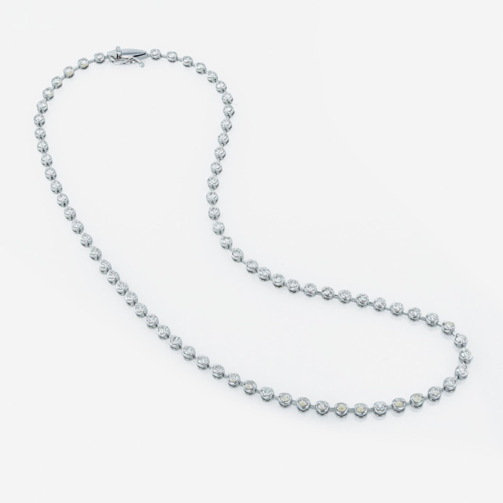 An 18K white gold and diamond necklace: An 18K white gold and diamond necklace designed as eighteen karat white gold circular links connected by bars, each link set with a round brilliant-cut diamonds; estimated total diamond weight: 6.00 c