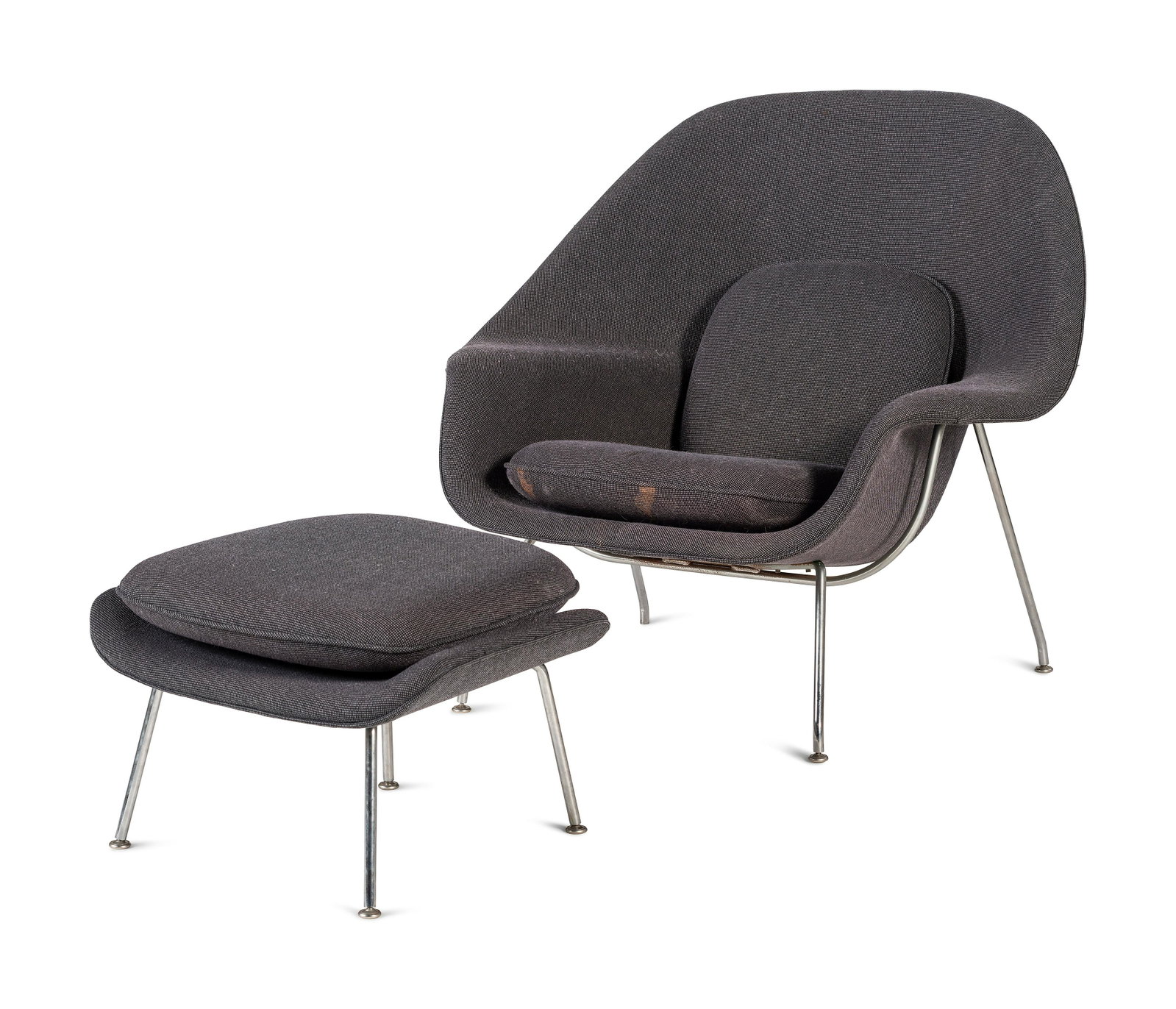 A Mid-Century Modern Womb Chair and Ottoman: A Mid-Century Modern Womb Chair and Ottoman in the style of Eero Saarinen for Knoll. Height of chair 35 1/2 x width 40 x depth 32 inches. Property from the Collection of Robert B. Riley, Urbana, Illin