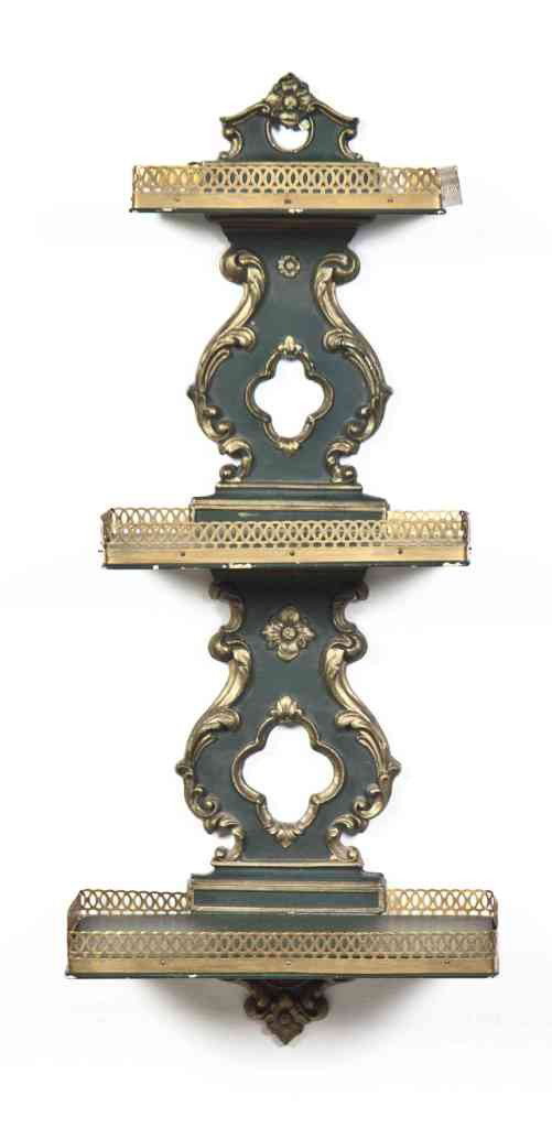 A Painted and Parcel Gilt Wall Bracket, Height 24: A Painted and Parcel Gilt Wall Bracket, having three rectangular galleried shelves set on a scrolling foliate backplate. Height 24 1/8 inches.