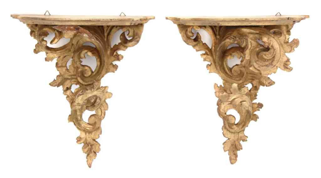 A Pair of Rococo Style Giltwood Wall Brackets, He: A Pair of Rococo Style Giltwood Wall Brackets, 20th century, each with a foliate carved support. Height 13 1/2 inches. Property from the William H. Moore Trust, Dorset, Vermont