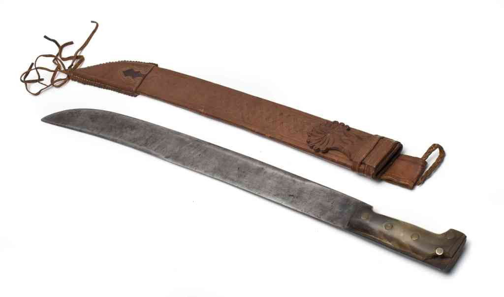 A Steel Machete, Macero, Length overall 27 3/4 in: A Steel Machete, Macero, with leather scabbard. Length overall 27 3/4 inches. Property from the Private Collection of a Doctor, Lake Forest, Illinois