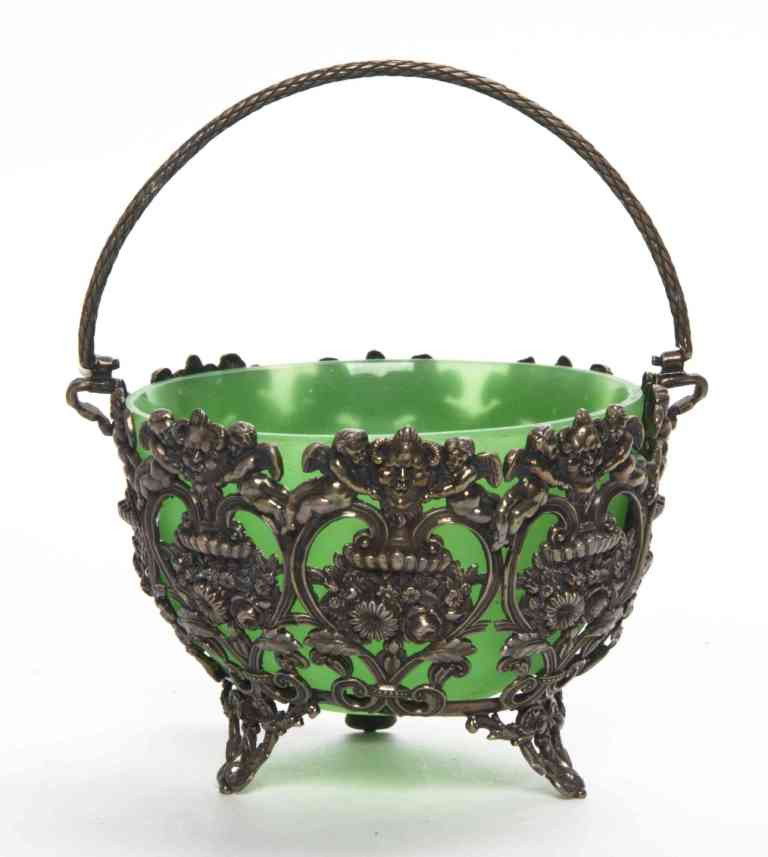 A Silver Mounted Opaline Glass Bowl, Height over: A Silver Mounted Opaline Glass Bowl, with swing handle. Height over handle 6 inches. Property from the Estate of Norma B. Harris, Chicago, Illinois